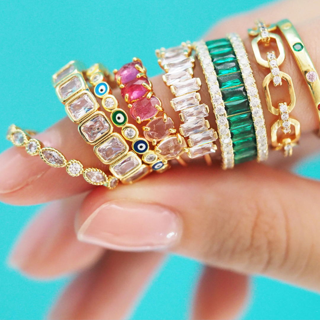 Finger holding 8 rings - Variety of ring styles at Tai Jewelry